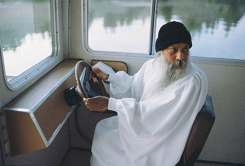 osho at the steering-wheel of a boat